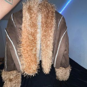 Fuzzy trim contrast brown and tan coat.